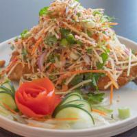 Rainbow Trout Salad · Deep-fried boneless rainbow Trout topped with shredded apples, red onion, cashew nuts, roast...
