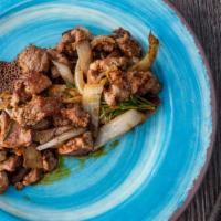 Lamb Tibs · Cubed lamb sautéed with onions, jalapenos and tomatoes sautéed with special tadu berbere bas...