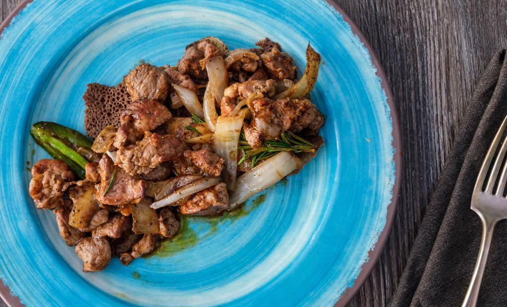 Lamb Tibs · Cubed lamb sautéed with onions, jalapenos and tomatoes sautéed with special tadu berbere based spices.