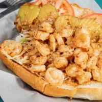 BBQ Shrimp Po Boy · A Poor House favorite! Sautéed shrimp in a spicy and tangy New Orleans BBQ sauce. Shredded c...