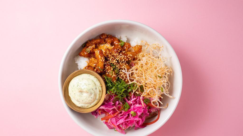 Korean Chicken Rice Bowl · Crispy chicken mixed in a vibrant red sauce, Bánh mì slaw, Thai basil Mayo and togarashi crispy rice noodles over steamed rice.