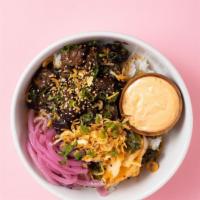 Braised Beef Rice Bowl · Korean braised beef served with garlic sauce, kimchi, green onions and sesame over steamed r...