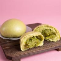(2) Matcha Bao · Two Soft, fluffy, and pillowy steamed buns filled with matcha custard.
