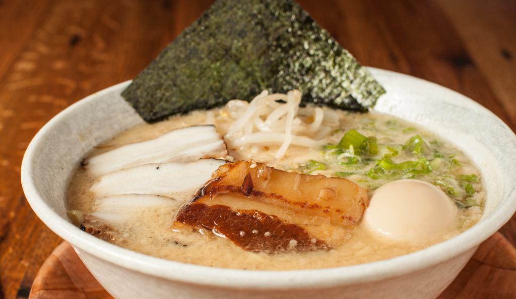 Tonkotsu Deluxe Ramen · Bean sprout, green onions, sesame, chashu, kakuni (slow cooked pork belly), egg, and dry seaweed.