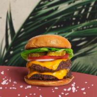 Double Team Vegan Cheese Burger · Two seasoned vegan burger patties topped with vegan cheese, lettuce, tomato, onion, and pick...