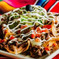 Coronel's Nachos · Crispy tortilla chips with refried beans, Monterey jack cheese and your choice of meat (shre...