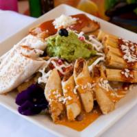 El Coronel's Sampler Plate · Nachos, chicken quesadilla, flauta, taquitos and tamal. Served with jalapeños, tomato. Guaca...