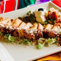 Taquitos · Crispy corn tortillas stuffed with shredded chicken. Served with guacamole, sour cream. Coti...