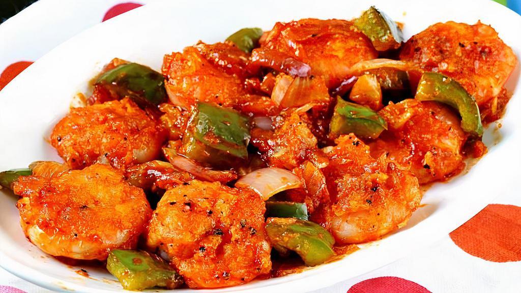 Chilli Prawns · A sizzling combination of sauteed prawns, umpteen sauces and fresh greens onions