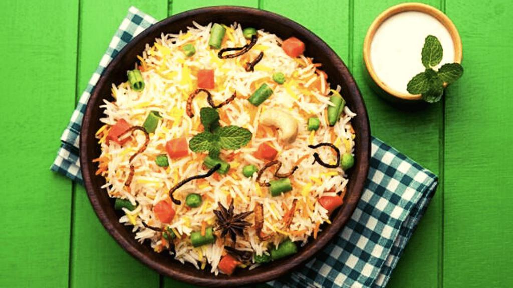 Veg Biryani · Vegetable biryani is an aromatic rice dish made by cooking basmati rice with mix veggies, herbs & biryani spices.