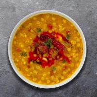 Dial Up The Daal · Yellow lentils, slow cooked to perfection and tempered with cumin, garlic and chilies.