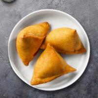 Crispy Samosas · Flaky pastry dumplings filled with spiced potatoes, vegetables and deep fried till crisp and...