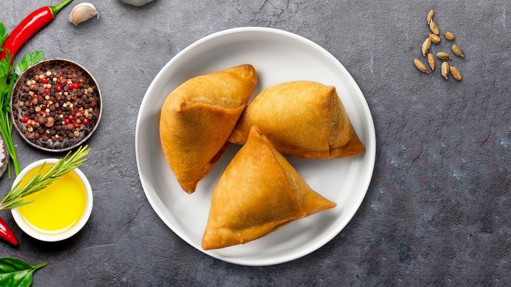 Crispy Samosas · Flaky pastry dumplings filled with spiced potatoes, vegetables and deep fried till crisp and golden.