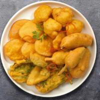 Golden Fried Vegetable Fritters · Mixed seasonal veggies, seasoned and batter fried till crisp and golden.