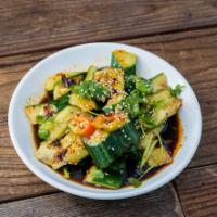 S1. Spicy cucumber salad / 拍黄瓜 · Cucumbers cut and smashed tossed in garlic black vinegar and chili oil.