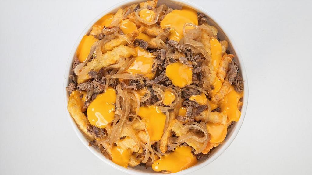 Loaded Cheesesteak Fries · Thinly sliced steak & griddled onions with cheese sauce on a bed of French fries
