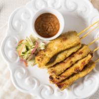 Chicken Satay · Grilled chicken skewers served with cucumber salad and peanut sauce.