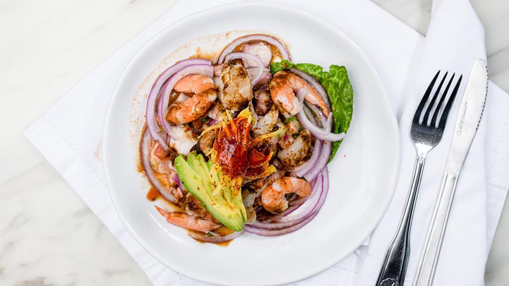 Tostada Mixta · Raw , tanned and stitched shrimp, abulon, octopus, scallops   special black sauce.