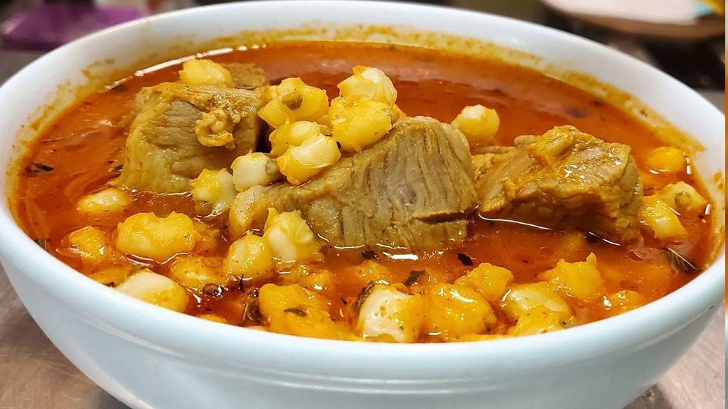 Pozole · pork meat soup with hominy, serve with lemon, cabbage, yellow onions, oregano, spicy oil chili sauce and tostadas on the side.