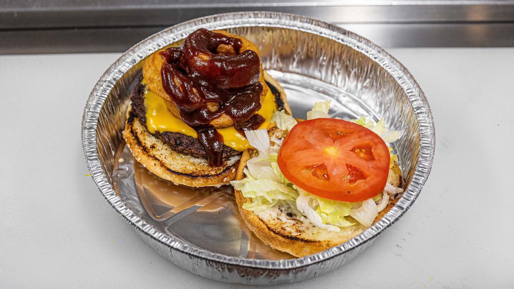 Rodeo Burger · 100% Freshly Grilled Beef Patty topped with Fried Onion Rings, BBQ Sauce, Mayonnaise, Lettuce, and Tomato served on a Toasted Bun