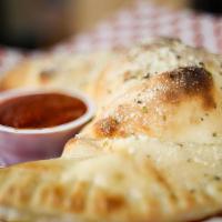 Spinach Calzone · With feta cheese, sun-dried tomatoes and kalamata olives.