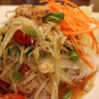 Som Tum Goong Yang Salad · Shredded green papaya salad with grilled shrimp, green beans, tomatoes and ground peanuts in...