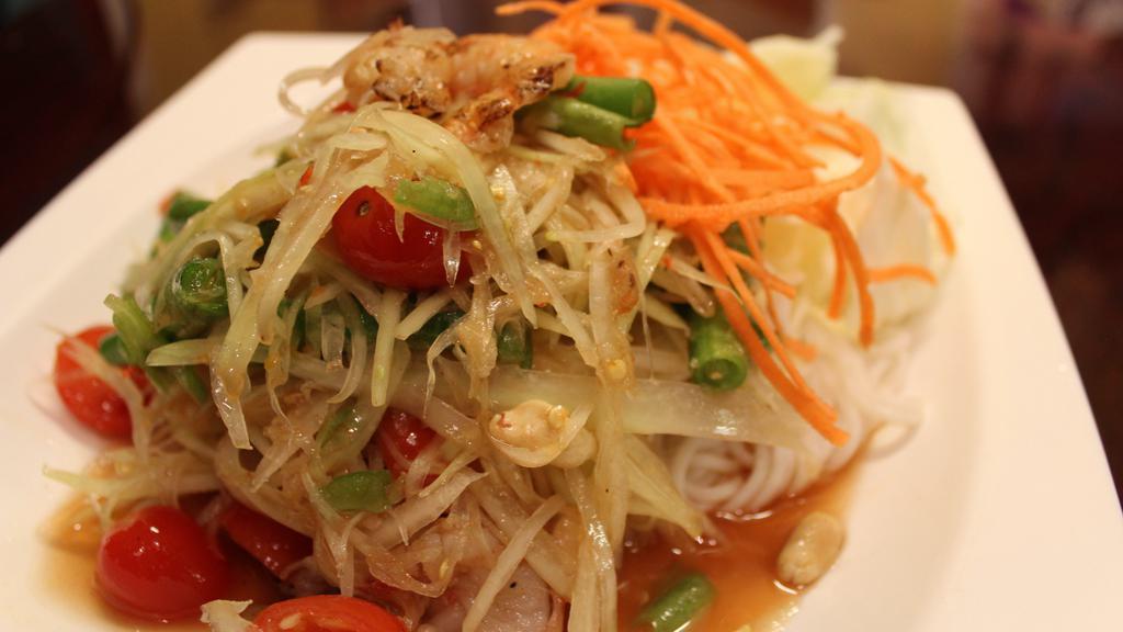 Som Tum Goong Yang Salad · Shredded green papaya salad with grilled shrimp, green beans, tomatoes and ground peanuts in a chili-lime dressing.