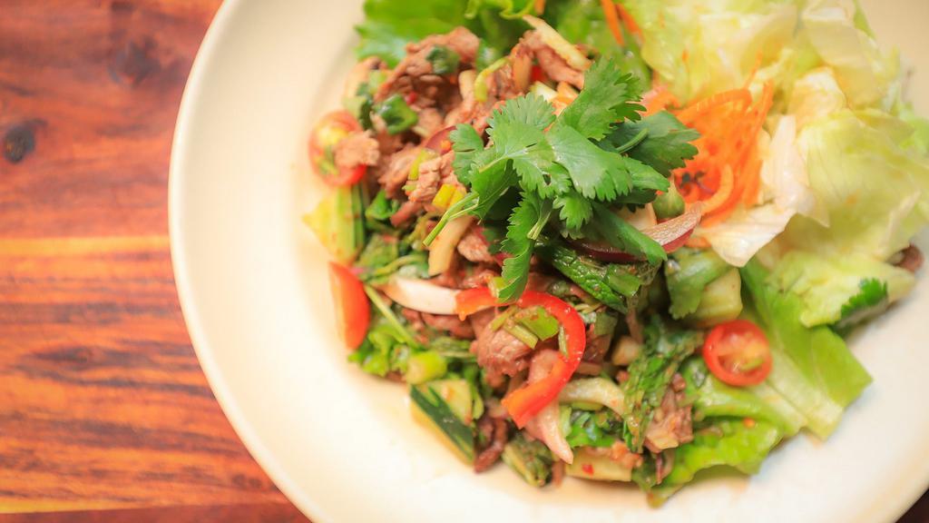 23. Yum Nuer (Beef Salad) · Hot. Beef salad mixed with onions, chili, cucumber, basil and tomatoes in lime dressing.