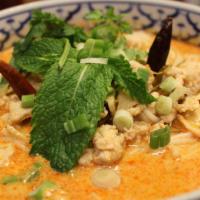 Kao Poon Noodle Soup · Special red coconut curry soup served with round rice noodles, chicken, shredded cabbage, an...