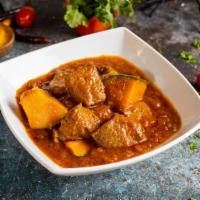 Burmese Style Lamb Curry  · Poached diced lamb simmered with freshly ground spices. Gluten-free.