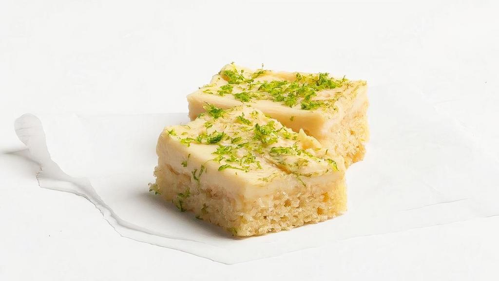 Key Lime Cake · Tangy lime cake topped with a layer of  key lime cheesecake and lime zest.