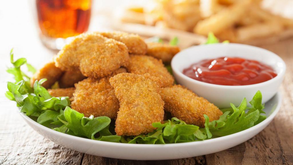 Crispy Chicken Nuggets with Fries · Crispy golden chicken nuggets served with French fries.