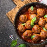 Meatballs · Juicy meaty meatballs drenched in marinara sauce and mozzarella cheese.