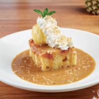 Pineapple Upside-Down Cake · Warm pineapple upside-down cake, on a bed of kahlúa cream sauce. Topped with vanilla ice cre...