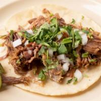 Hand made tortilla taco · Choice of meat, onion and cilantro