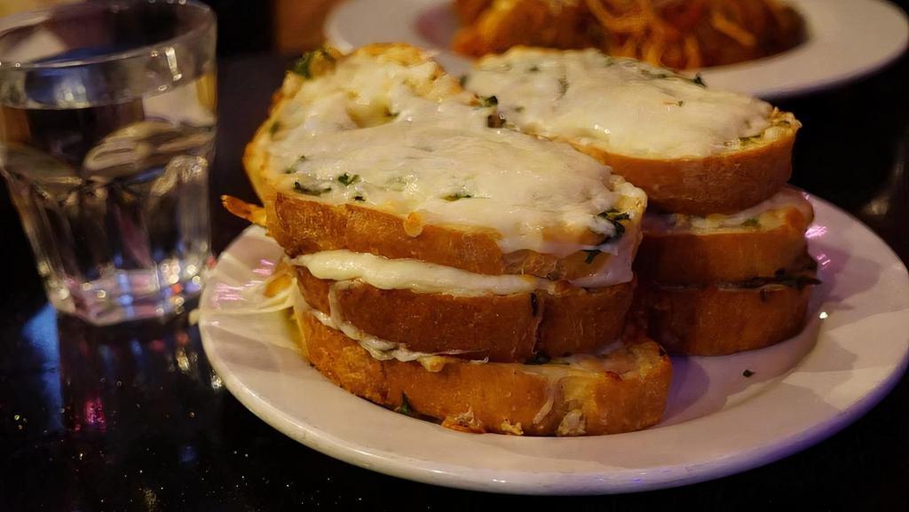 Garlic Bread · Choose from a small and large portion or add melted mozzarella cheese ;-0