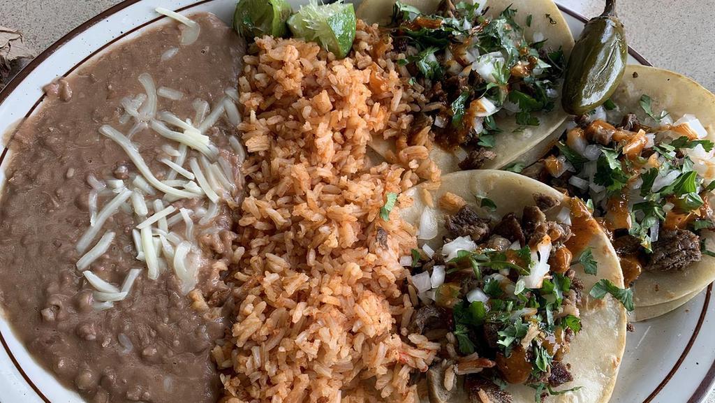 Taco Plate · Three Regular Tacos with Onions and Cilantro , (Choice of Meat) Rice and Beans