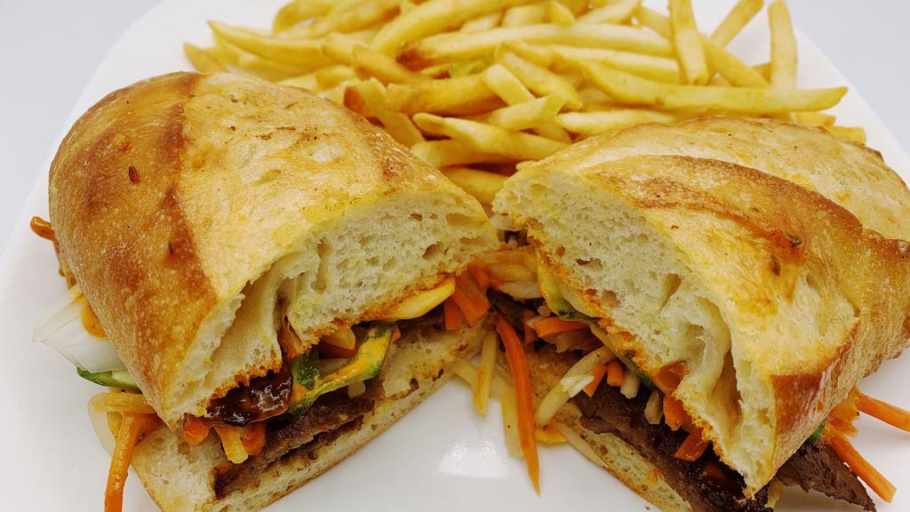 Bahn Mi · Choice of meat. Served with pickled daikon and carrots, sliced jalapenos, onions, cilantro and topped with sriracha aioli on baguette. Served with fries.