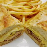 Cuban · Grilled marinated pork, grilled ham, pickles, spicy mustard and swiss cheese on baguette. Se...