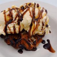 Belgium Waffle Sundae · Belgium waffle served with vanilla ice cream,  chocolate sauce,  caramel sauce and a cherry ...