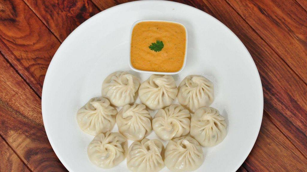 Himalayan style Chicken Momos 8 Pieces · Steamed Stuffed chicken dumpling himalayan style served with tangy herb and tomato
sauce.