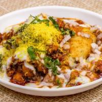 Aloo tikki Chaat · Fried mashed potatoes stuffed with peas and cheese served on bed of garbanzo peas.