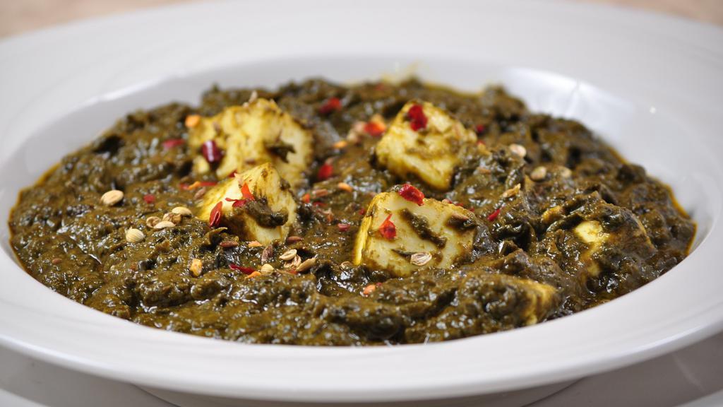 Palak Paneer · Green spinach cooked with onion garlic and cottage cheese.