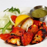 Achari chicken tikka · Tender chicken thigh meat cooked in a charcoal tandoor oven with fenugreek and
indian spices...
