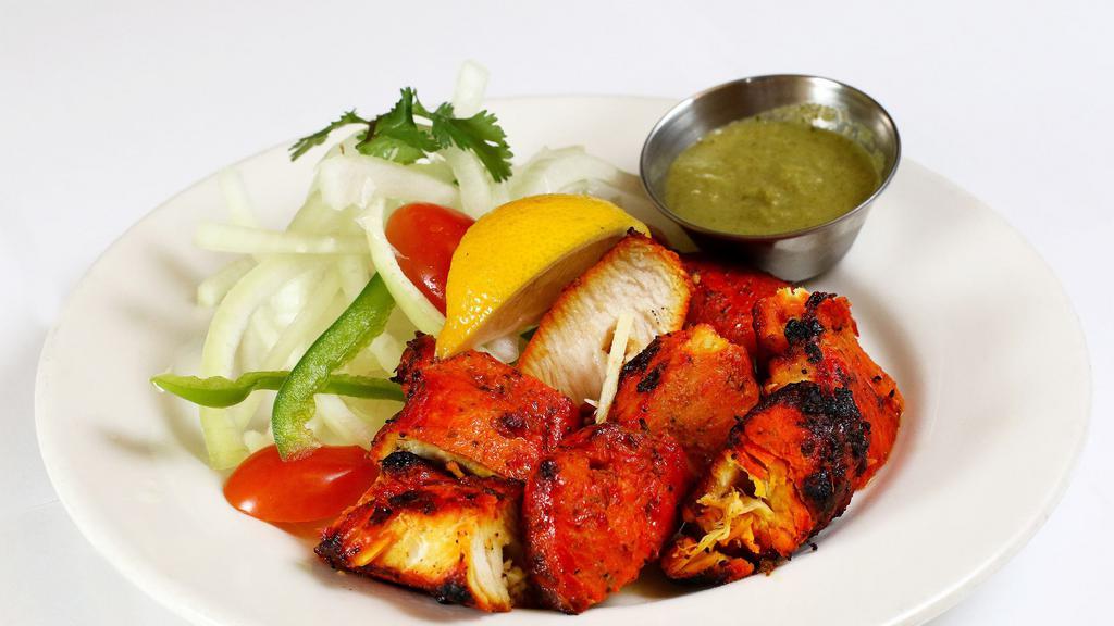 Achari chicken tikka · Tender chicken thigh meat cooked in a charcoal tandoor oven with fenugreek and
indian spices, ginger and garlic.