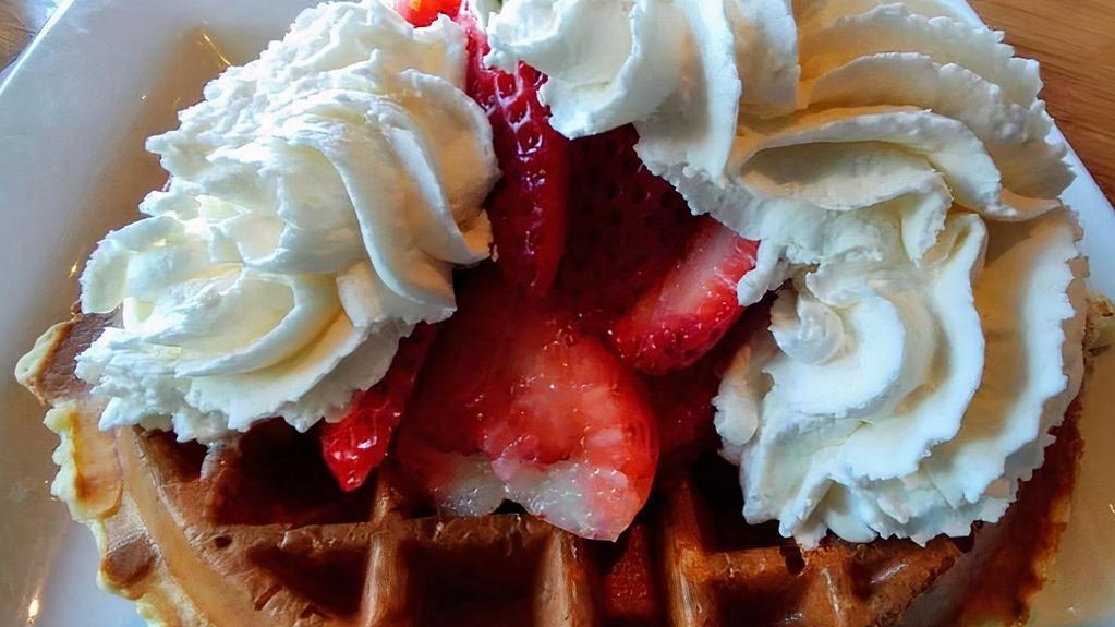 Strawberry Waffle · Topped with sliced strawberries and fresh whipped cream .