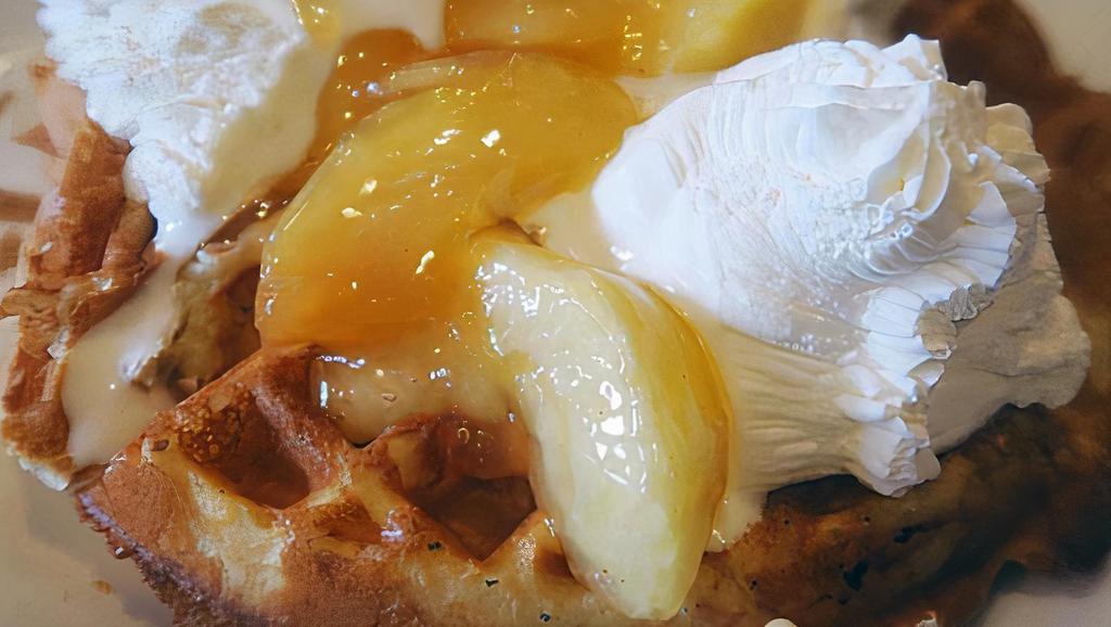 Apple Waffle · Topped with apples in a hot cinnamon glaze with fresh whipped cream.
