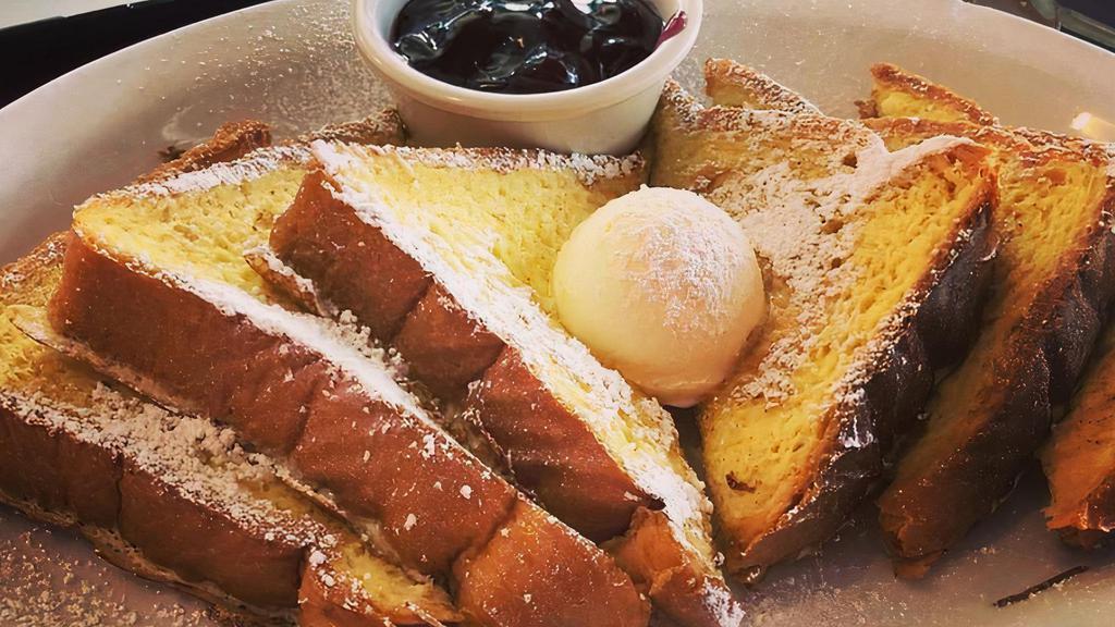 Texas Toast · 3 thick slices of dipped in an egg batter with vanilla, cream, and cinnamon. Served with your choice of hot apple, raspberry, blueberry, or strawberry compote.