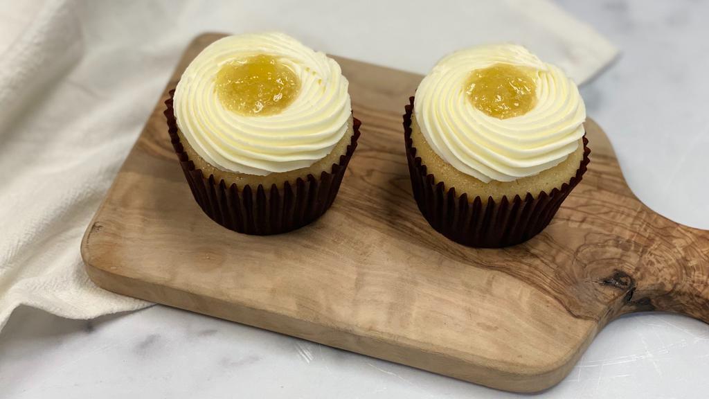 Golden Pineapple Cupcake · Two pieces. Set of 2 Vanilla cupcake with pineapple filling, topped with cream cheese frosting.