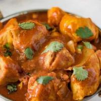 Chicken Madras · Spicy chili got chicken preparation from south India made with . crushed red chilies & hot m...